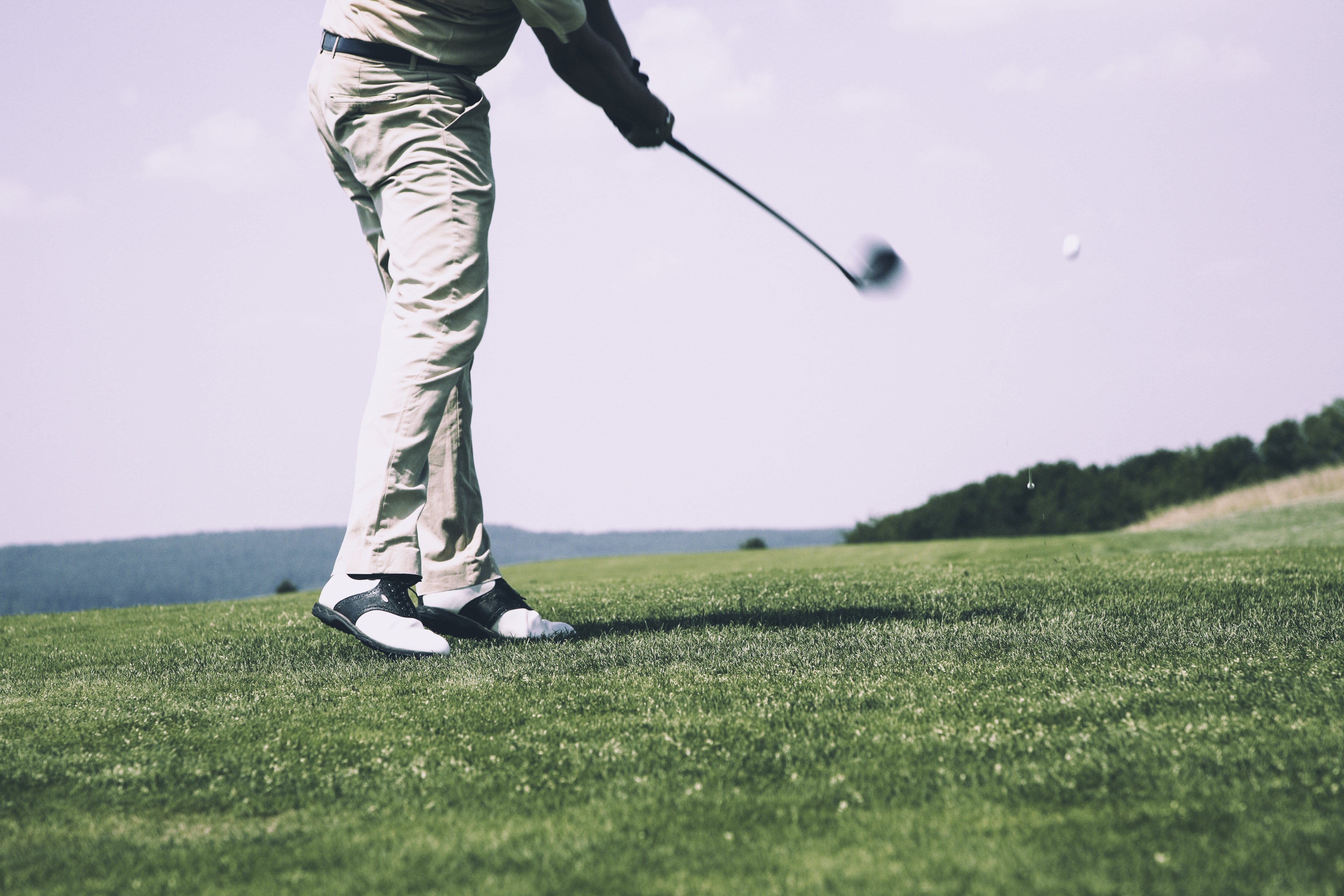 Man golfing on weed free grass